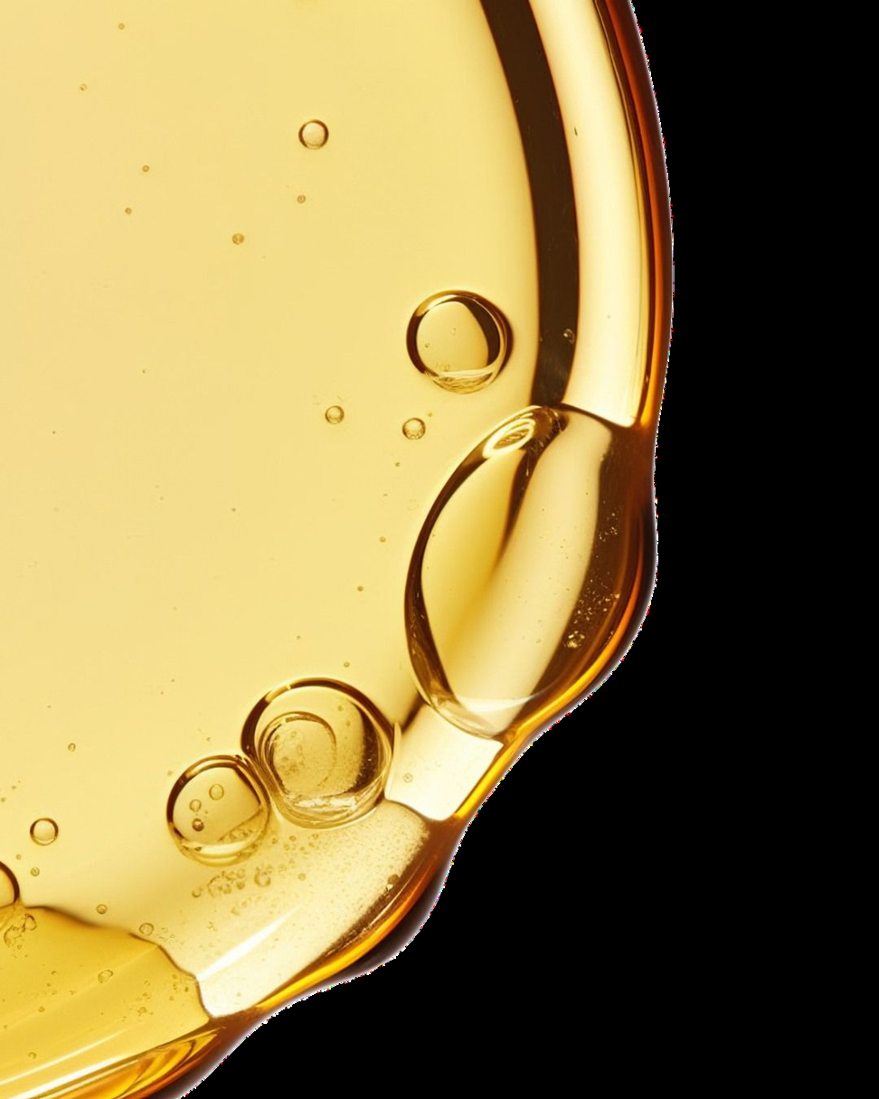 Mano e gocce di olio botanico dorato